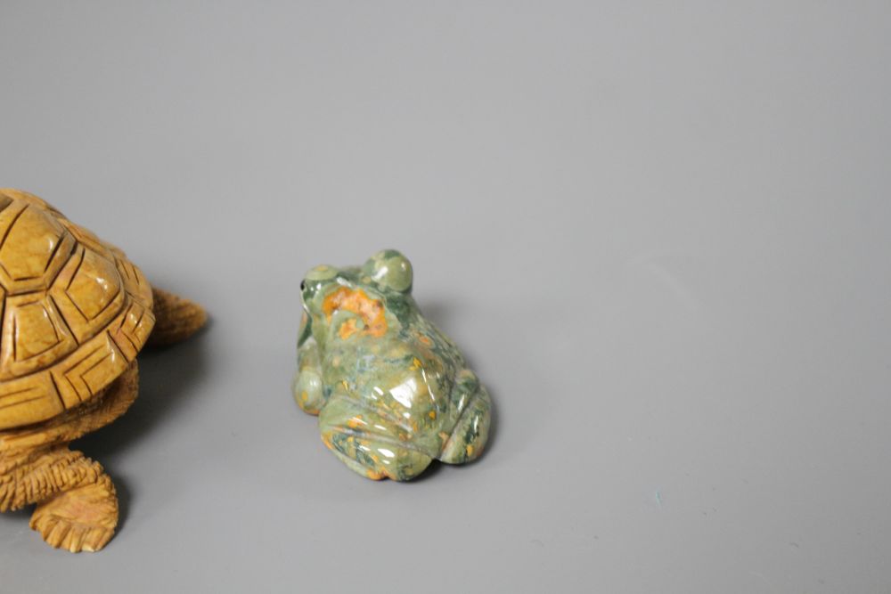 A carved fossil stone tortoise, 8cm and a carved Rhiolite carving of a frog, 4cm